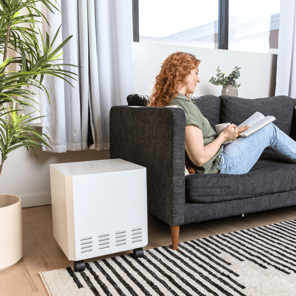 Female Reading On a Couch, Next to an EnviroKlenz Air System