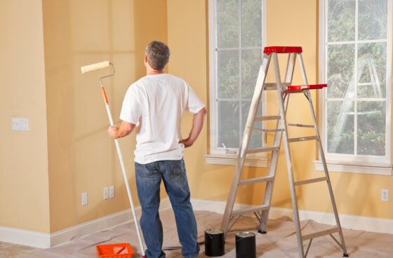 Man painting the inside of a home