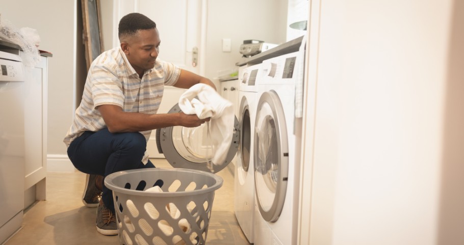 Man loading his washing machine