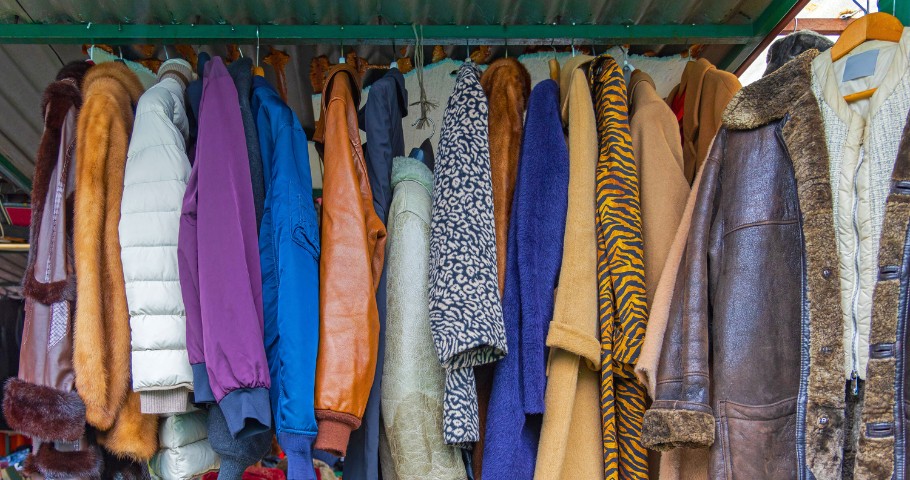 A rack of vintage clothes in a thrift store