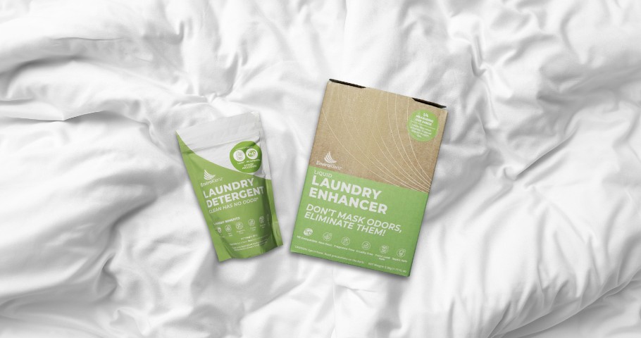 EnviroKlenz Laundry Detergent and Liquid Laundry Enhancer laying on white bedding