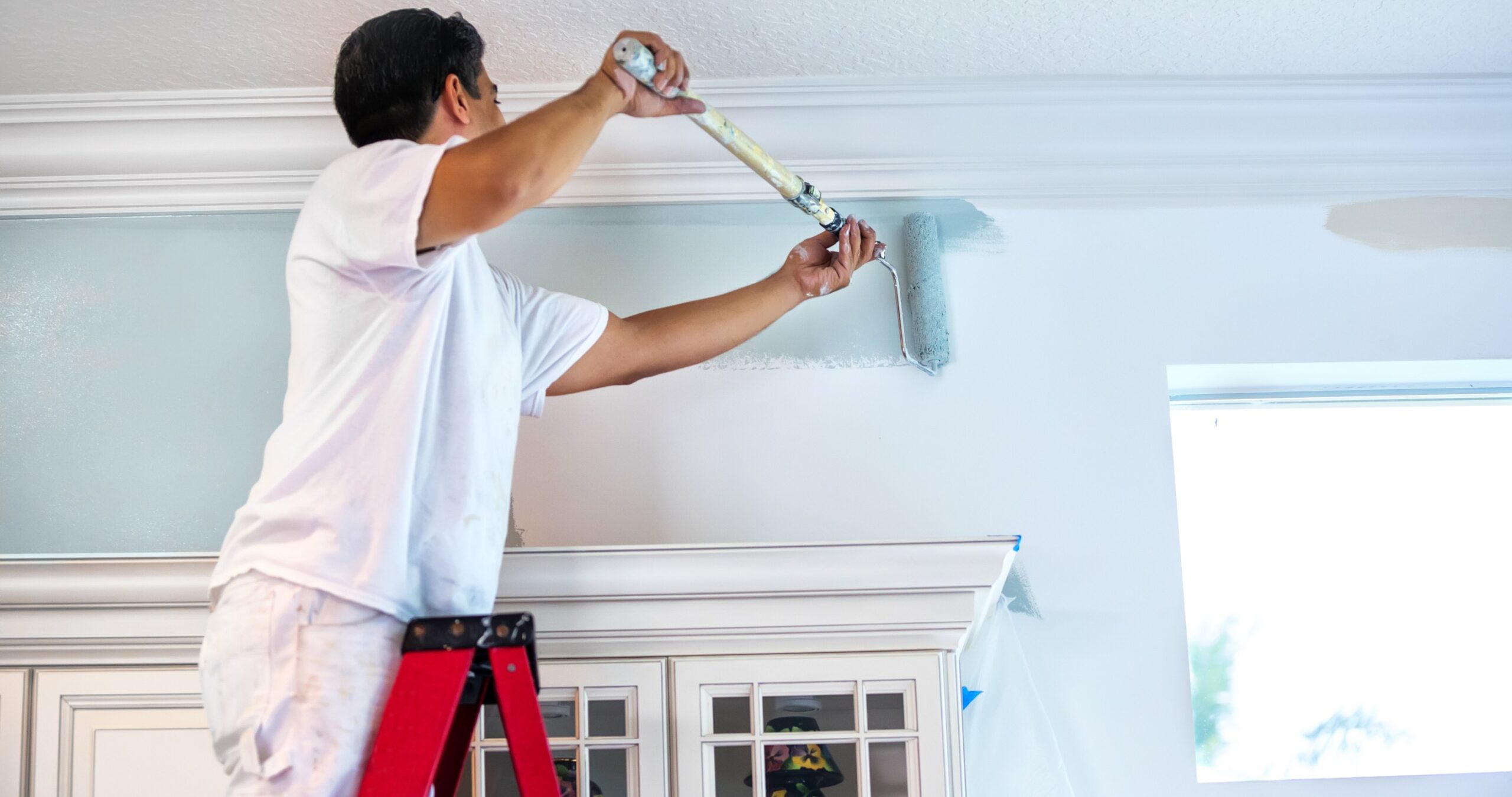 Man painting the inside of a house