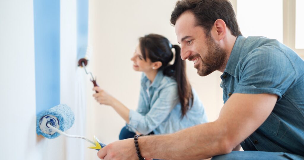 Couple painting the inside of their home